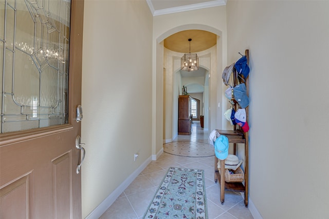 tiled foyer with a notable chandelier and ornamental molding