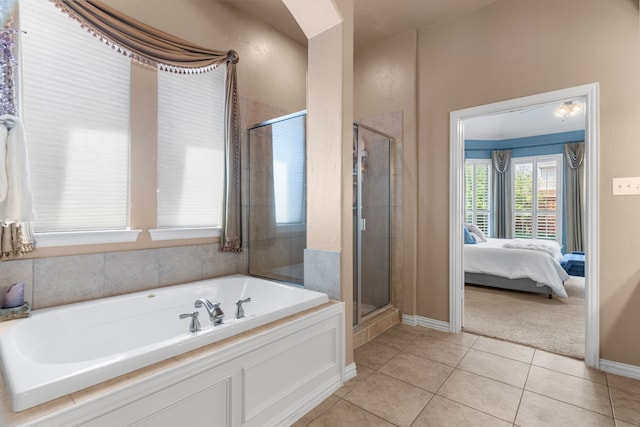 bathroom featuring separate shower and tub and tile patterned flooring