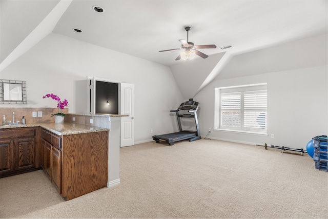 kitchen with light carpet, sink, vaulted ceiling, ceiling fan, and kitchen peninsula