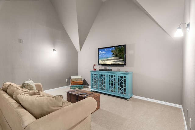 carpeted living room featuring high vaulted ceiling