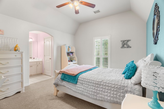 bedroom with connected bathroom, ceiling fan, light colored carpet, and lofted ceiling