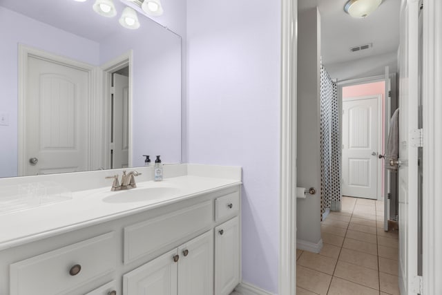 bathroom featuring tile patterned flooring and vanity