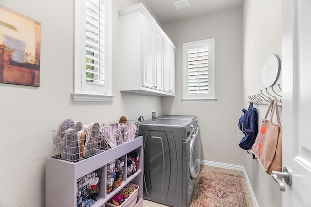 laundry room featuring cabinets and washer and dryer