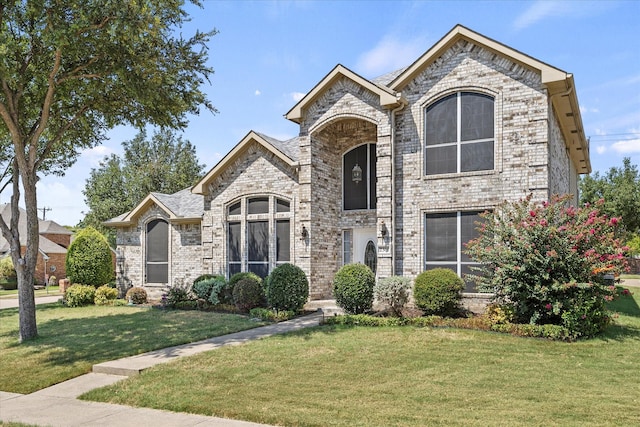 french country style house featuring a front yard