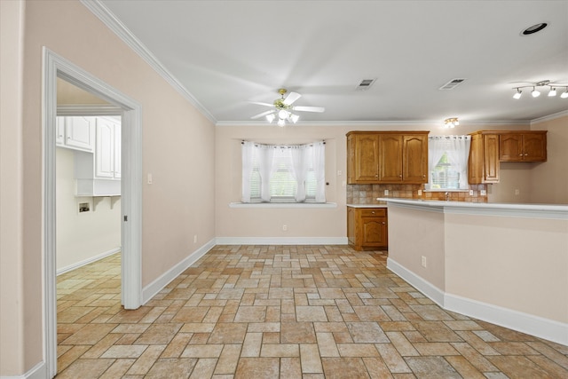 kitchen with backsplash, ornamental molding, and ceiling fan