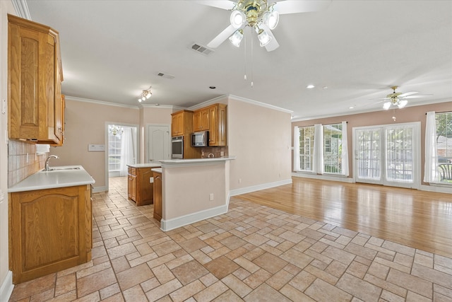 kitchen featuring stainless steel appliances, a healthy amount of sunlight, and decorative backsplash