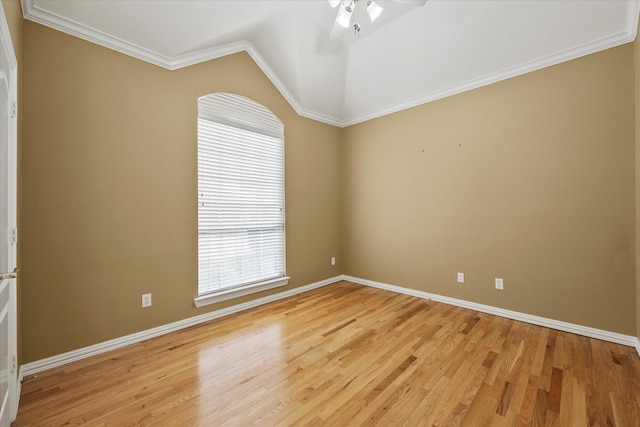 empty room featuring crown molding, vaulted ceiling, ceiling fan, and light hardwood / wood-style flooring