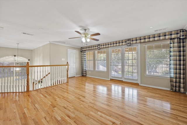 unfurnished room with ceiling fan, crown molding, and light hardwood / wood-style floors