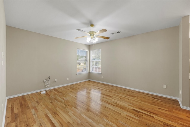 spare room featuring light hardwood / wood-style floors and ceiling fan