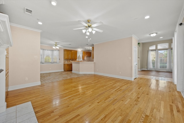 unfurnished living room featuring crown molding, ceiling fan, plenty of natural light, and light hardwood / wood-style flooring