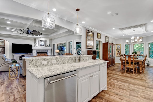 kitchen with dishwasher, white cabinetry, decorative light fixtures, and light hardwood / wood-style flooring