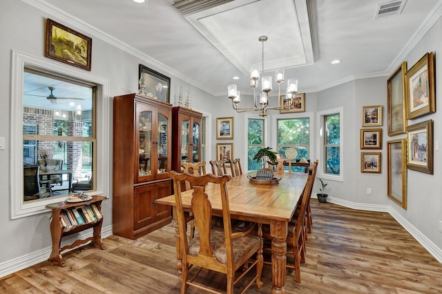 dining room with hardwood / wood-style floors, ceiling fan with notable chandelier, and ornamental molding