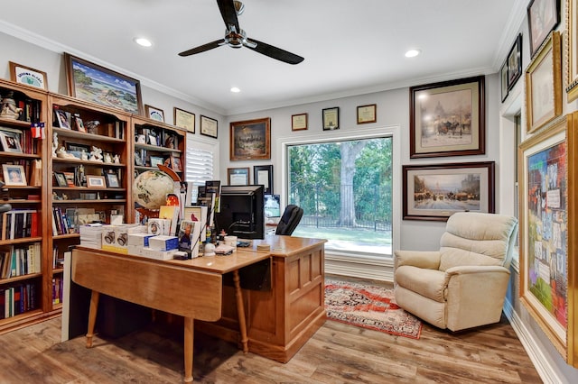 home office with light wood-type flooring, ceiling fan, and crown molding