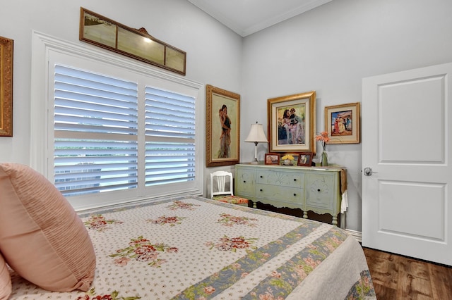 bedroom featuring dark hardwood / wood-style flooring and crown molding