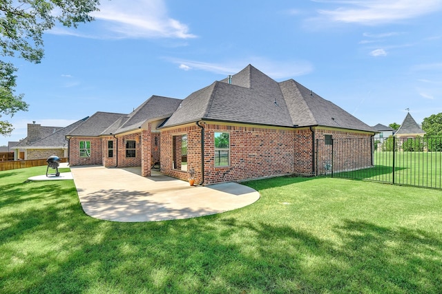 back of house with a patio and a lawn