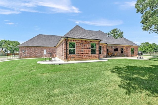 rear view of property featuring a patio area and a yard