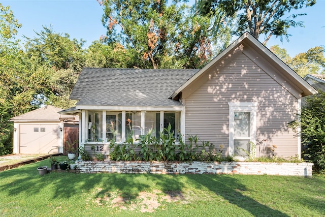 view of front of property featuring a garage and a front yard