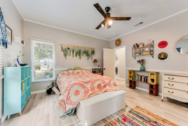 bedroom featuring light wood-type flooring, crown molding, and ceiling fan