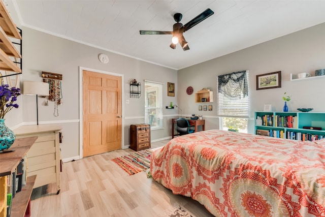 bedroom with ceiling fan, ornamental molding, and light hardwood / wood-style floors