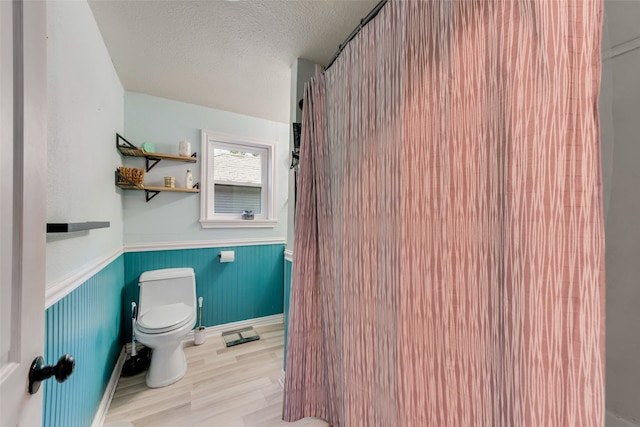 bathroom featuring a textured ceiling and toilet