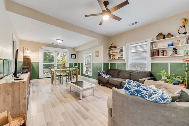 living room featuring ceiling fan and light hardwood / wood-style flooring