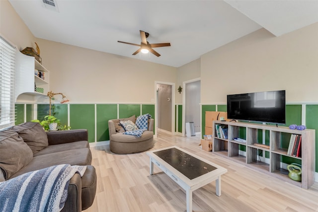 living room featuring ceiling fan and light hardwood / wood-style floors