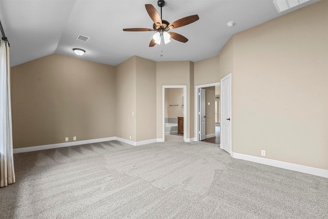 interior space featuring light colored carpet, ensuite bath, ceiling fan, and lofted ceiling