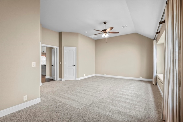 unfurnished room with carpet flooring, ceiling fan, and vaulted ceiling