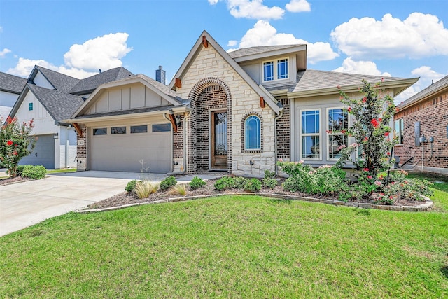 view of front of property featuring a front yard and a garage