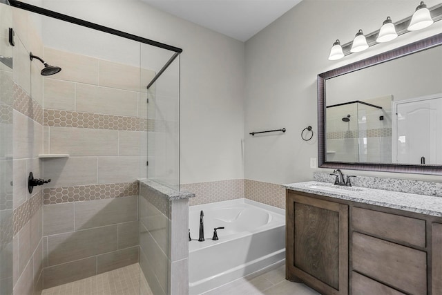 bathroom with tile patterned flooring, vanity, and plus walk in shower