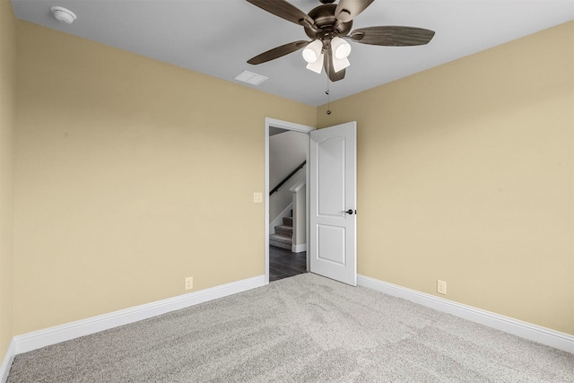 carpeted spare room with ceiling fan