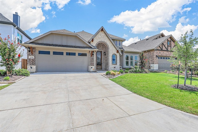 view of front of property with a front yard and a garage