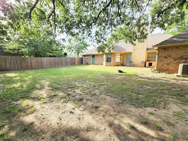 view of yard featuring central air condition unit