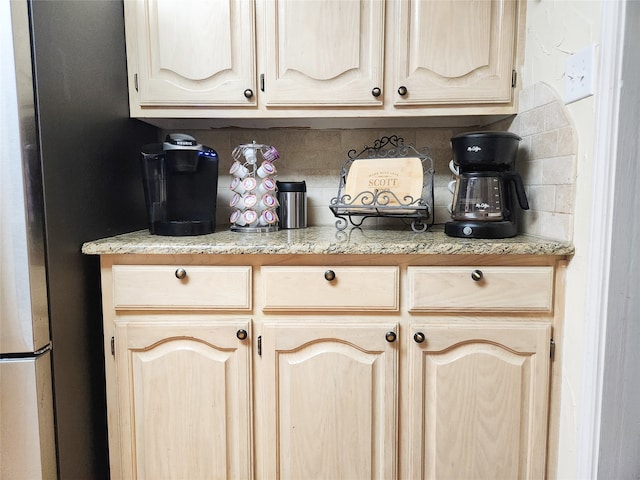 interior space featuring light brown cabinetry and backsplash