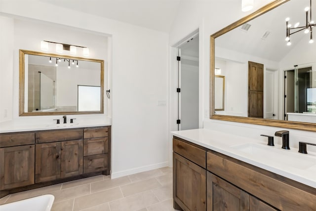 bathroom featuring tile patterned floors, a chandelier, lofted ceiling, a shower with door, and vanity