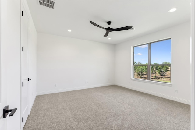 spare room with light carpet and ceiling fan