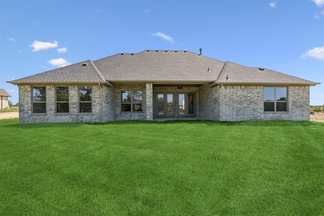 back of property with french doors and a yard