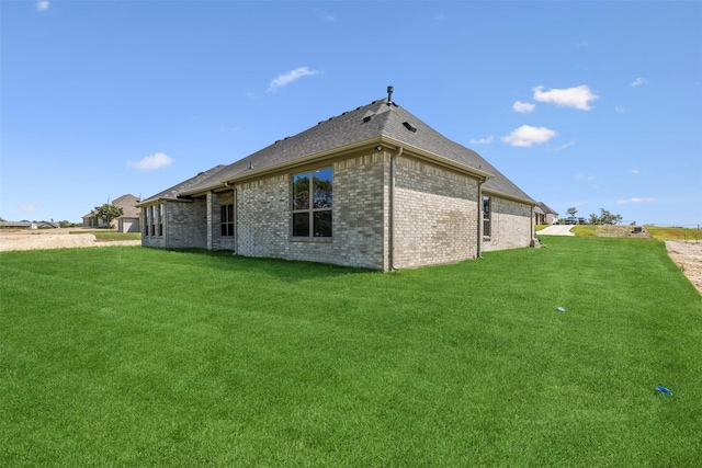 rear view of property with a lawn