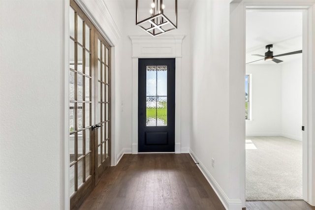 foyer featuring french doors, ceiling fan with notable chandelier, a wealth of natural light, and crown molding