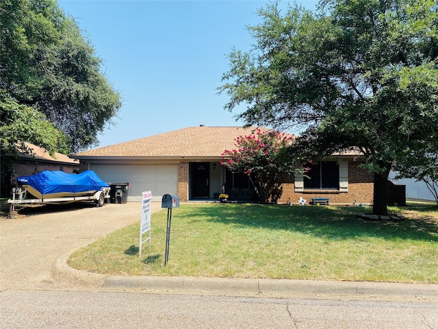 single story home with a garage and a front lawn