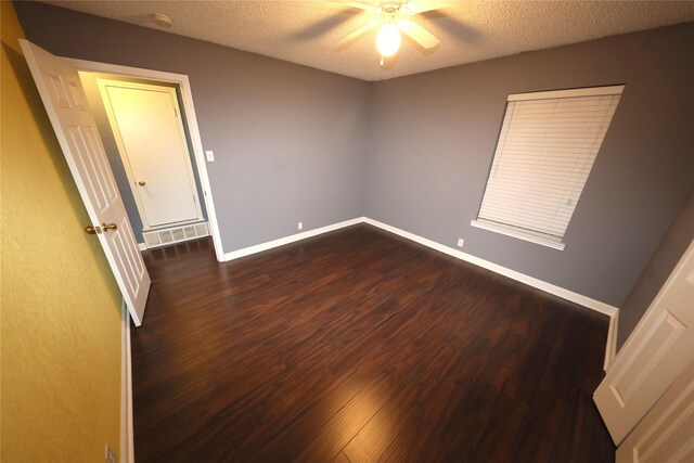 empty room featuring hardwood / wood-style floors, ceiling fan, and a textured ceiling