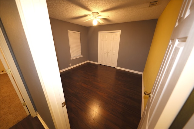 unfurnished room featuring a textured ceiling, ceiling fan, and wood-type flooring