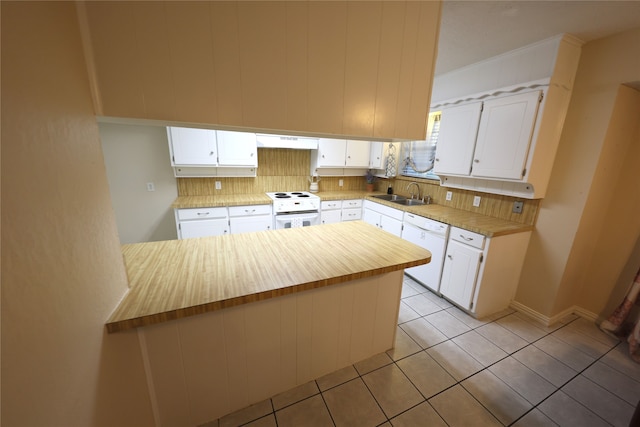 kitchen with tasteful backsplash, sink, white cabinets, white appliances, and custom exhaust hood