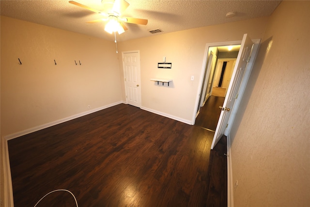 empty room with hardwood / wood-style floors, ceiling fan, and a textured ceiling