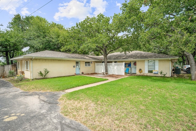 single story home with central AC and a front lawn