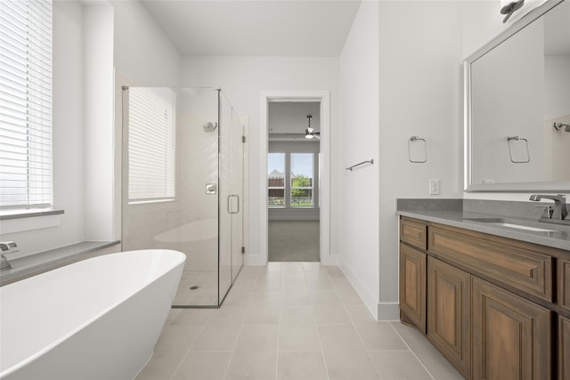 bathroom featuring vanity, independent shower and bath, and tile patterned floors