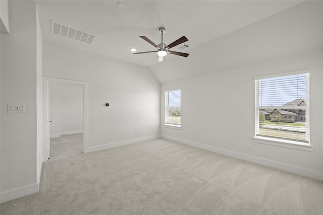 carpeted empty room featuring lofted ceiling and ceiling fan