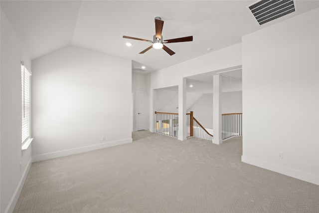 carpeted empty room with lofted ceiling and ceiling fan