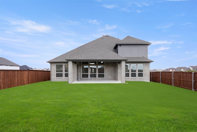 rear view of property featuring a patio area and a yard