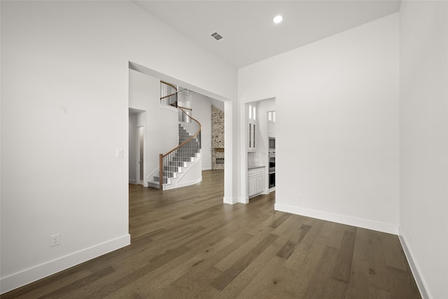 hallway with dark hardwood / wood-style flooring